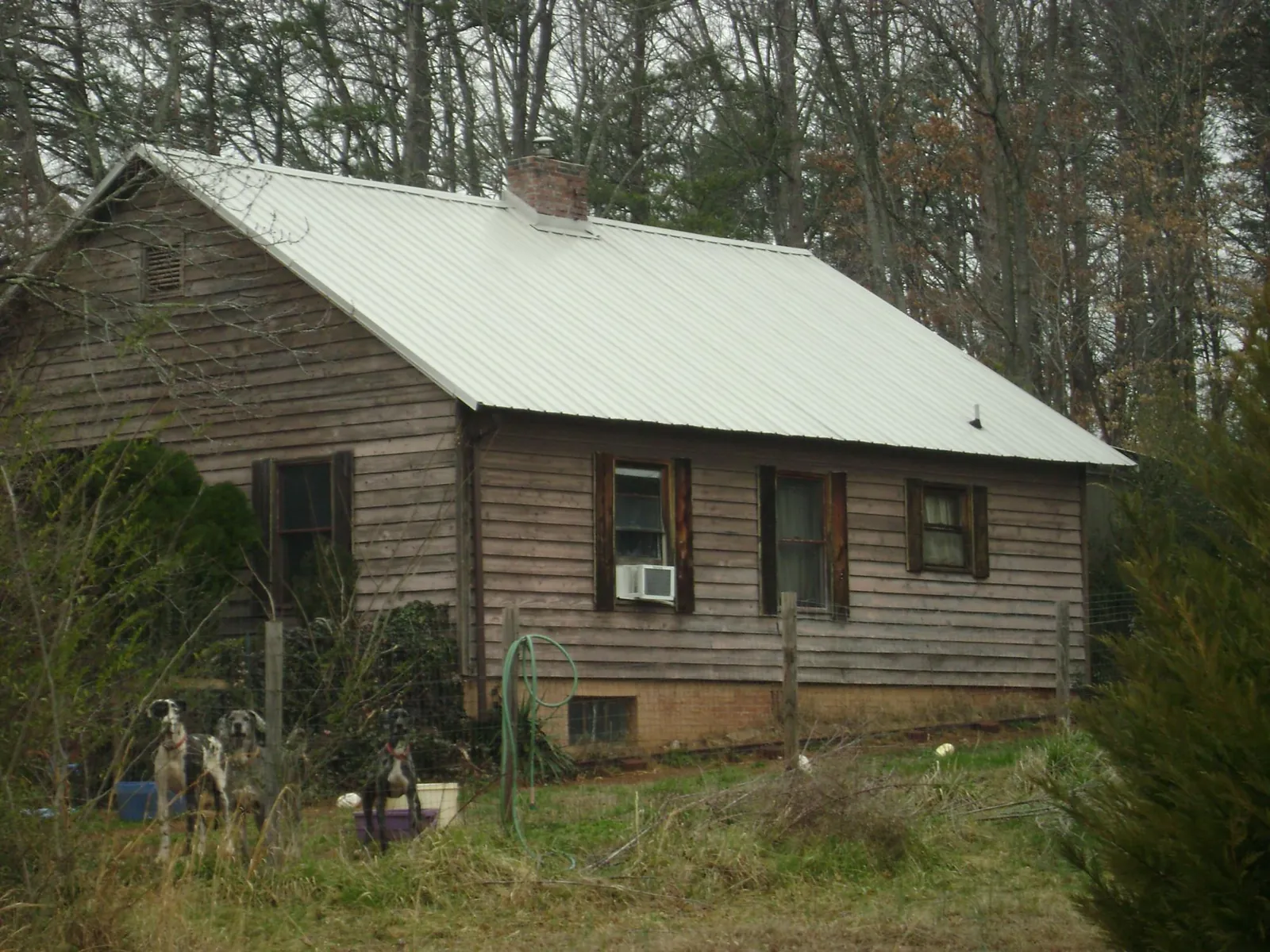 White metal roof on an old wood sided farmhouse, from a Asphalt Shingle Roof Repair job in Gunlock
